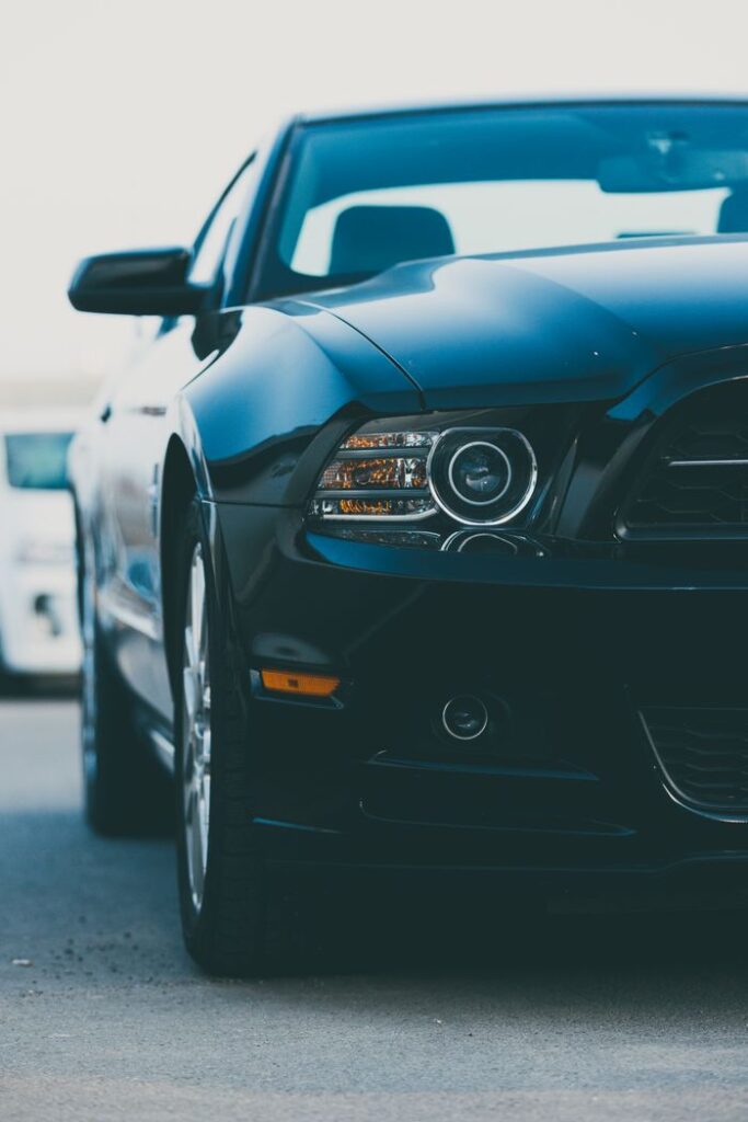 Close-up of a modern black sports car parked on a city street.